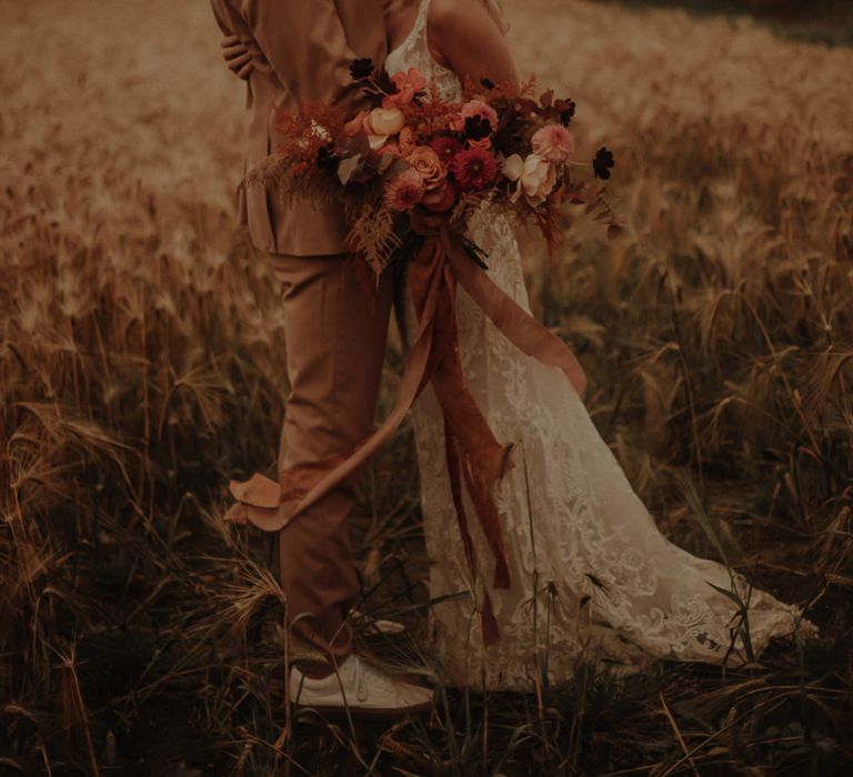 Bride in flower fedora hat and lace wedding dress