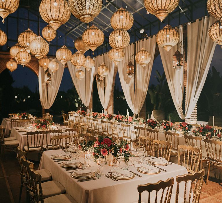 Luxury wedding reception with drapes and hanging Moroccan lanterns 