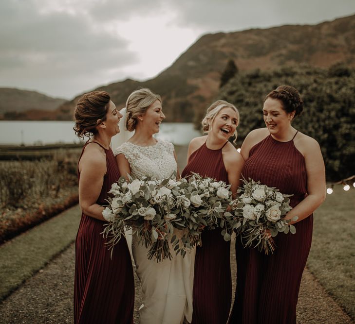 White rose wedding bouquets, burgundy bridesmaid dresses, festoon lights and picturesque views for Lake District Inn on the Lake wedding