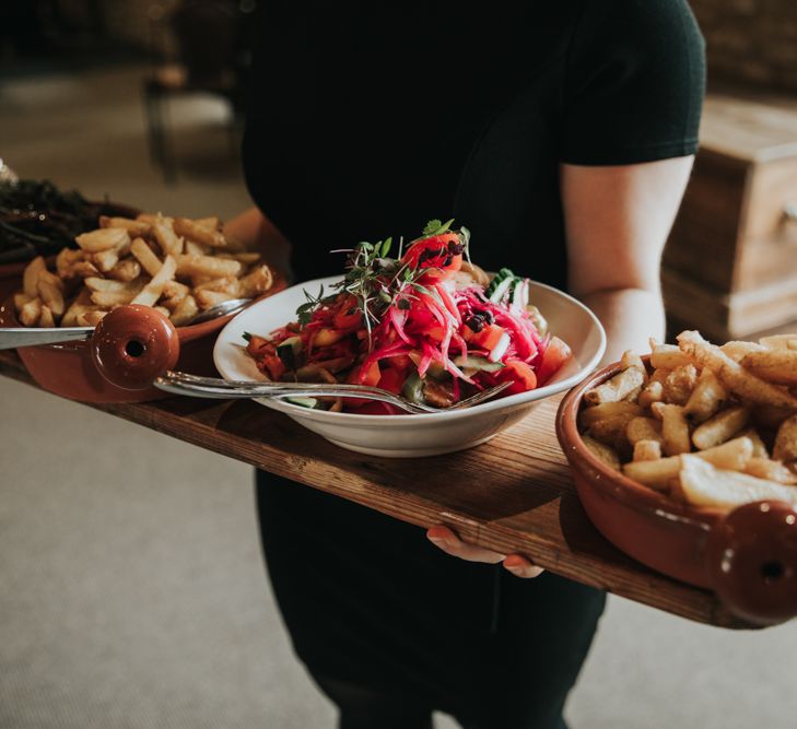 Burger and chips main meal on wooden planks at wedding breakfast