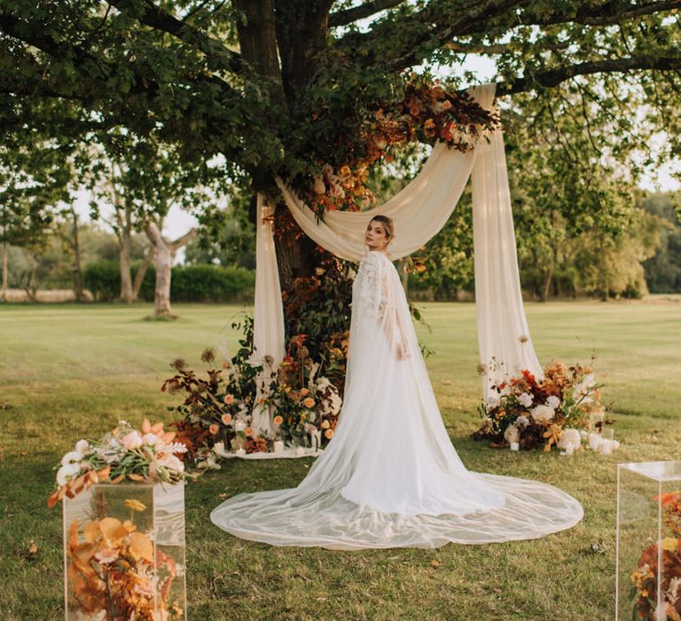 Bride at golden hour in outdoor Reymerston Hall ceremony