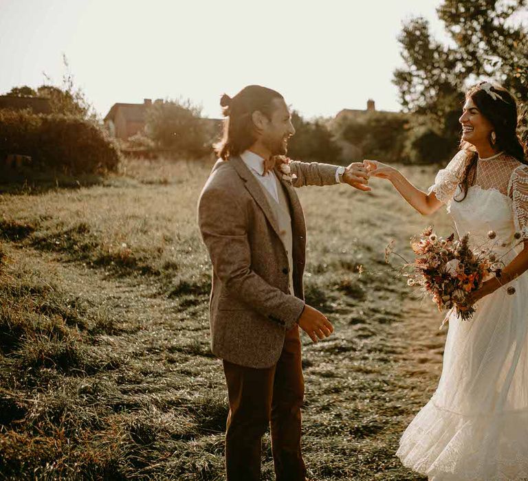 The bride and groom in the wild meadows of Cambridgeshire for their sustainable wedding