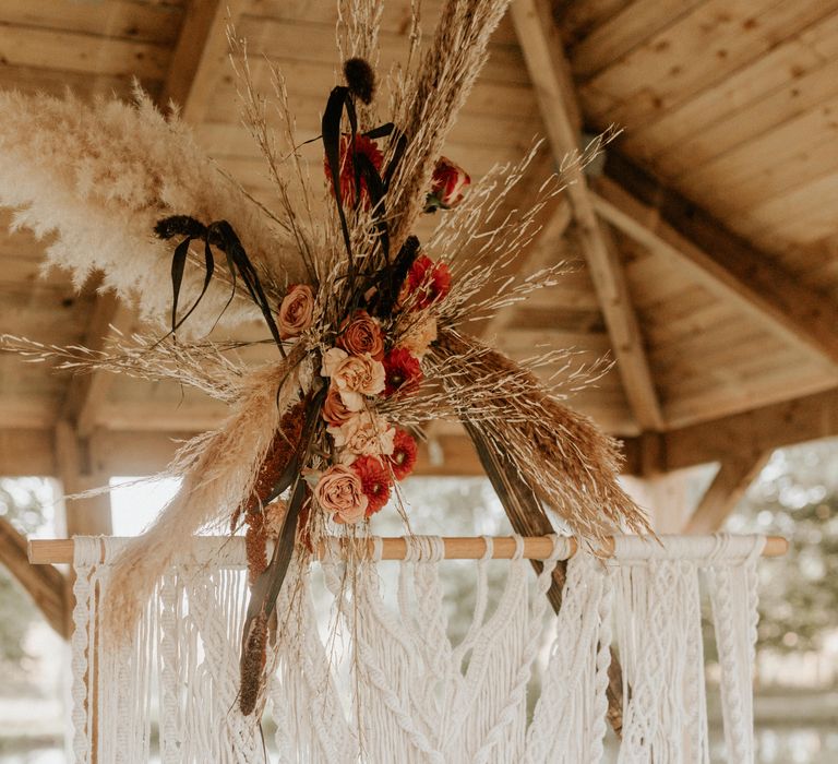 White macrame hanging with floral decoration 