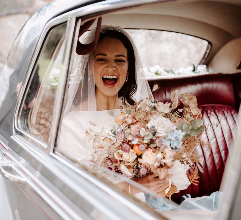 Bide laughs in car as she pulls up to church wedding ceremony