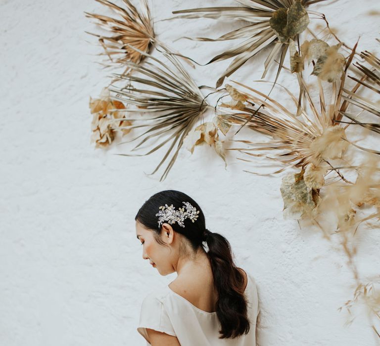 The bride wearing a relaxed silk short sleeved bridal top and flowing skirt