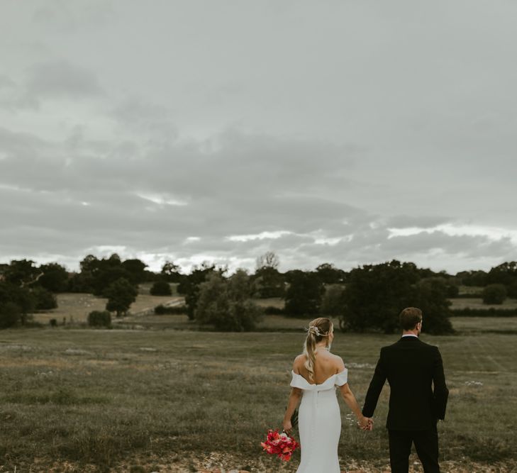 Bride & groom look across the countryside together