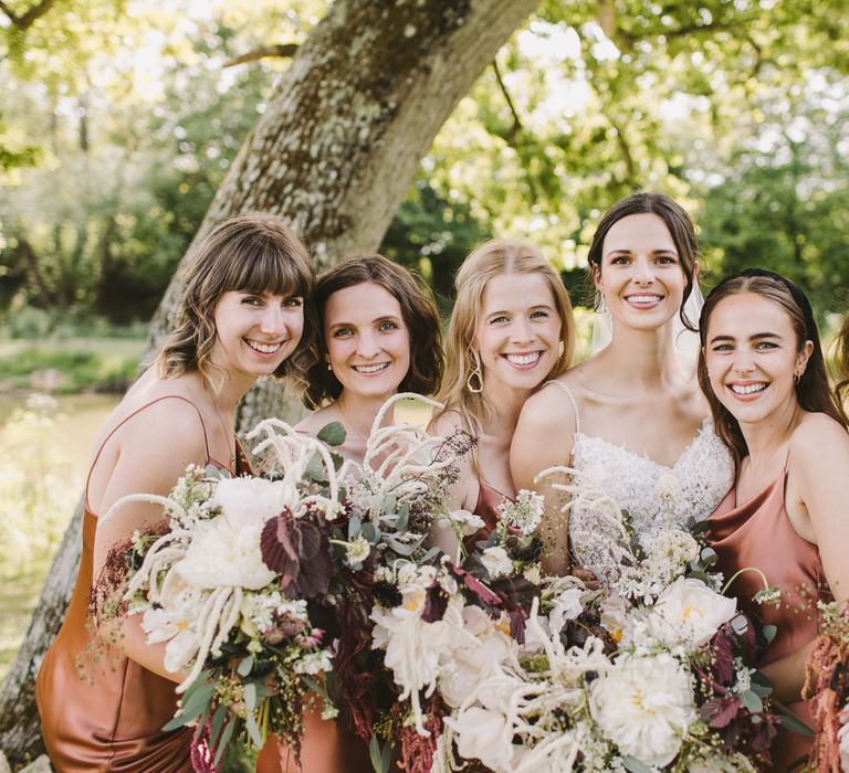 Bride stands with her bridesmaids