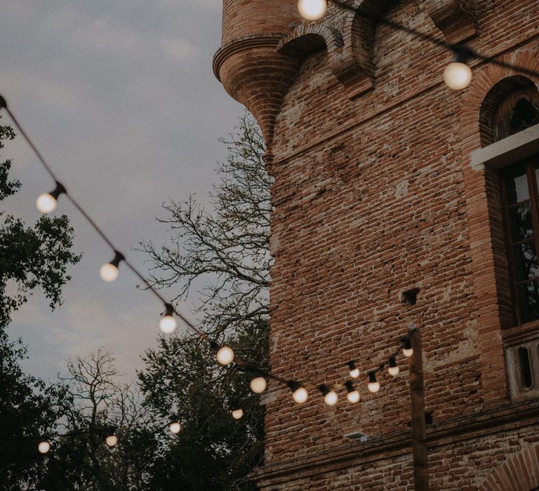 Festoon light wedding decor at French castle wedding 