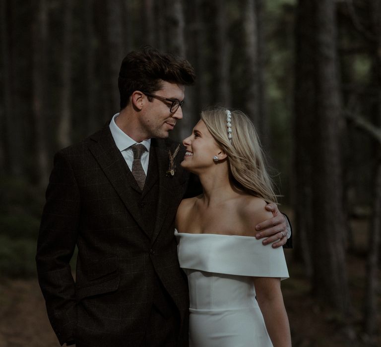 Bride & groom embrace on the day of their wedding in the woodlands