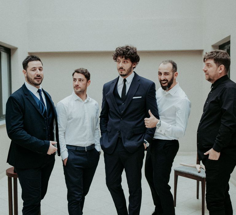 The groom and groomsmen getting ready in Mi-Ro suits