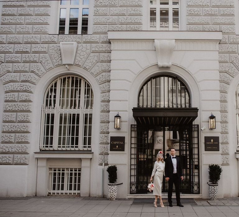 Bride and groom standing outside Amadria Park Hotel Capital Ballroom