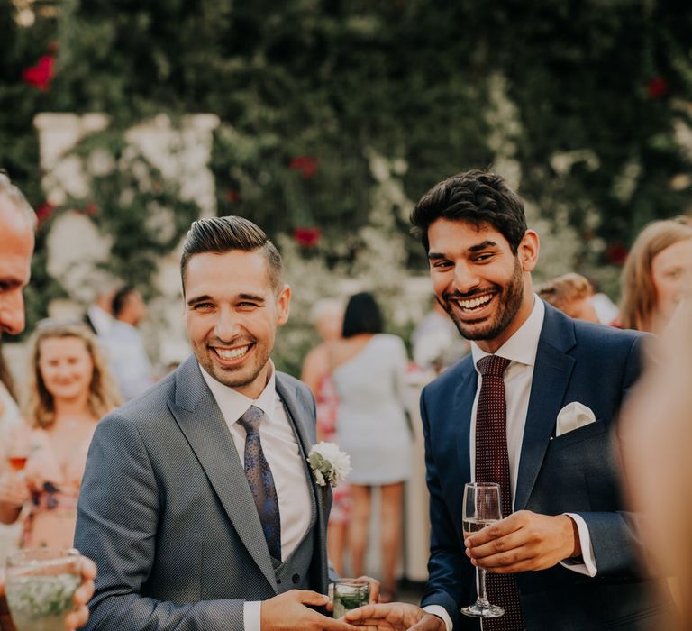 The groom laughing and chatting with guests