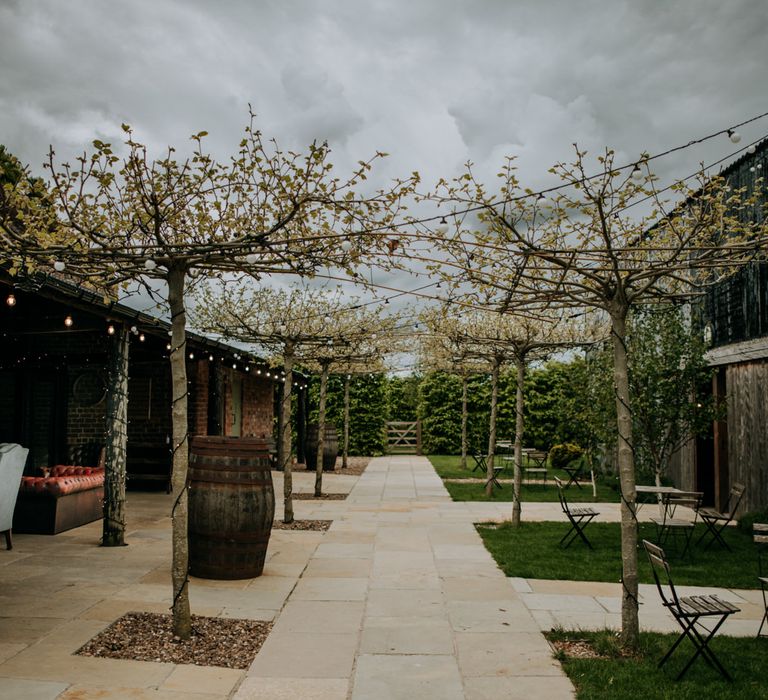 The courtyard at East Yorkshire Barns with trees lining the pathway 