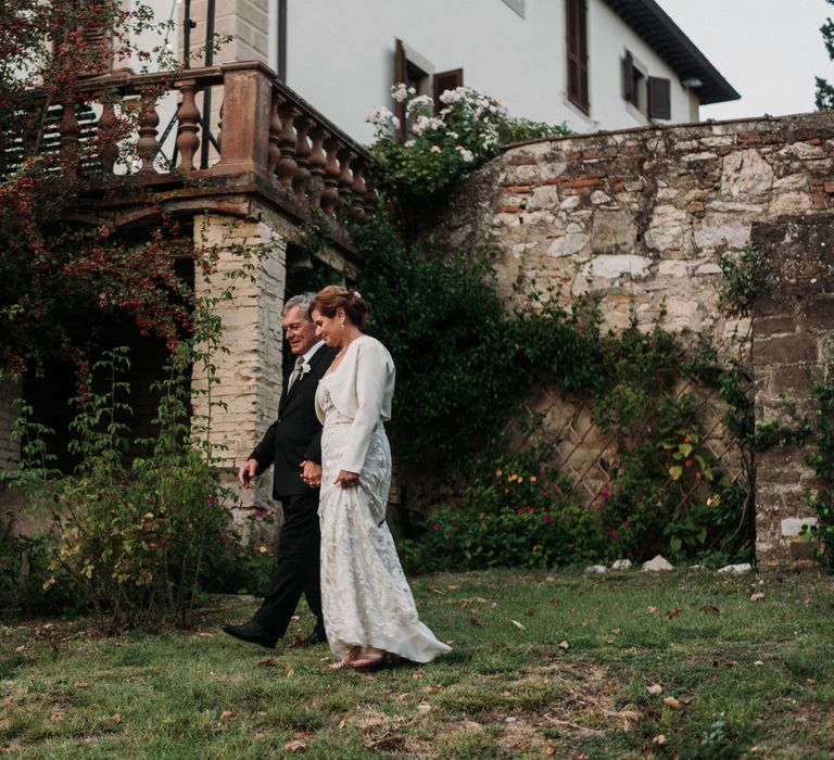 Bride & groom stand outside the Villa Pepi on their wedding day in Italy