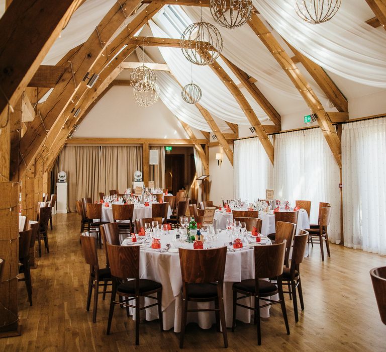 Wedding reception venue complete with hanging lights and knitted favours