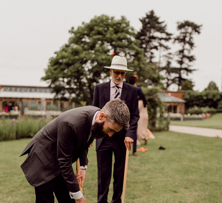 Wedding guests play garden games in Gaynes Park | Joshua Gooding Photography