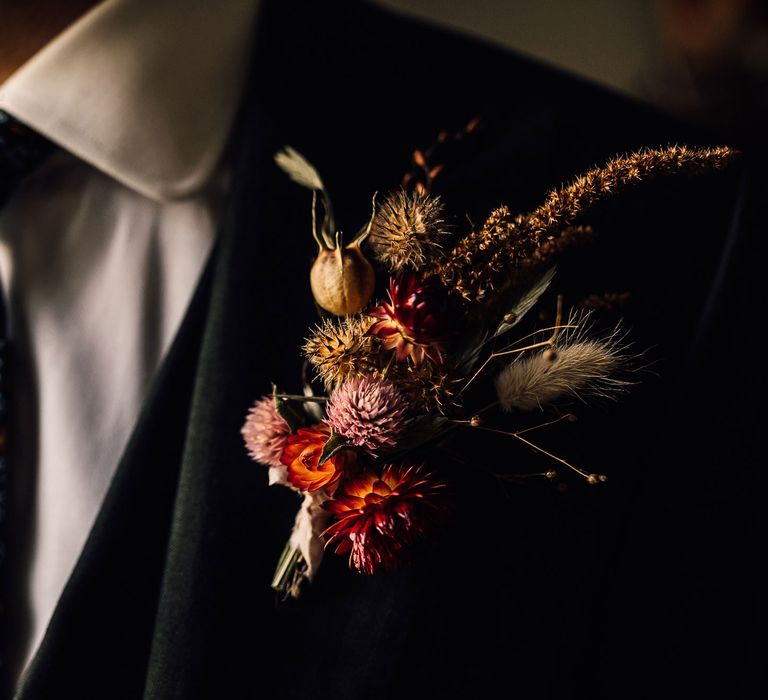 Groom in three piece suite, floral patterned tie and dried floral buttonhole before wedding in Cornwall with Halfpenny London Mayfair dress