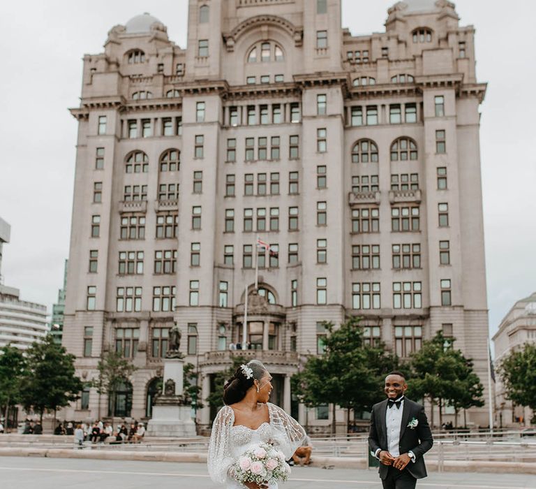 Bride & groom walk through Liverpool together on their wedding day