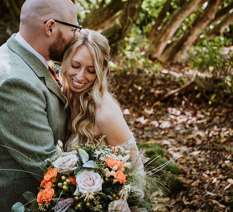 Bride & groom embrace outdoors on their wedding day