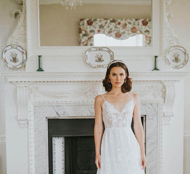 Bride in a Made With Love wedding dress with appliqué design and thin straps 