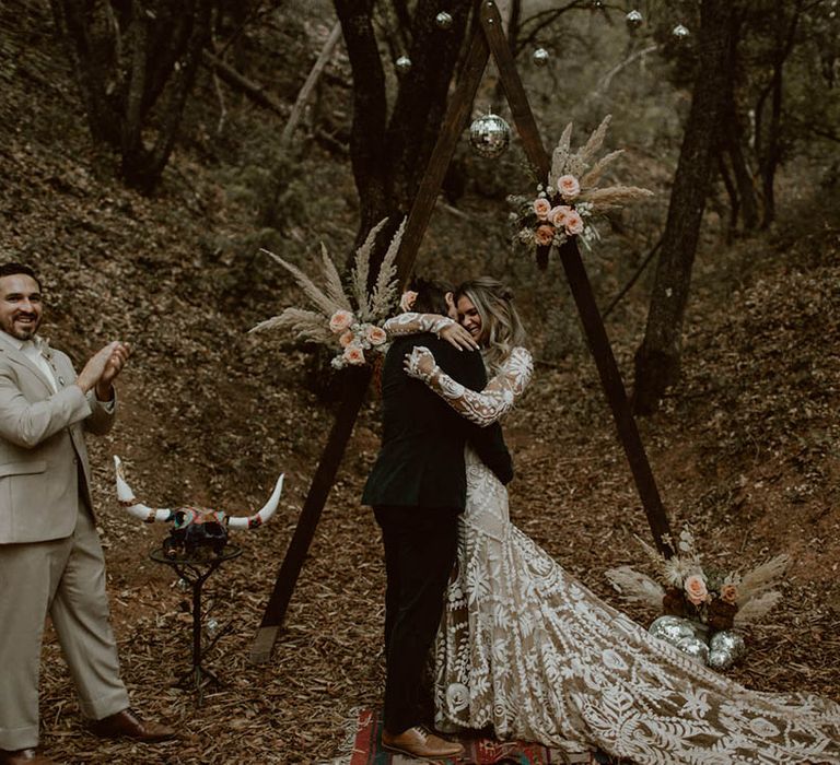 Bride & groom hug during reception 