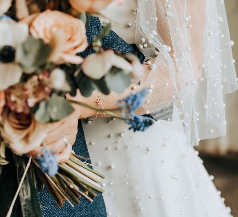 Pearl encrusted mesh sleeves of wedding dress for industrial style wedding