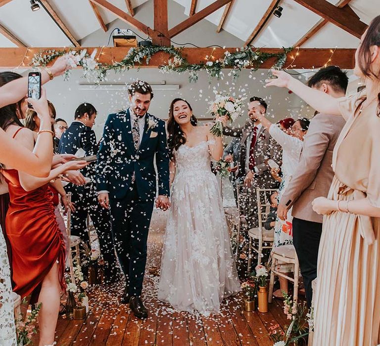 Bride and groom exit their ceremony to confetti at The Castlefield Rooms in Manchester city centre