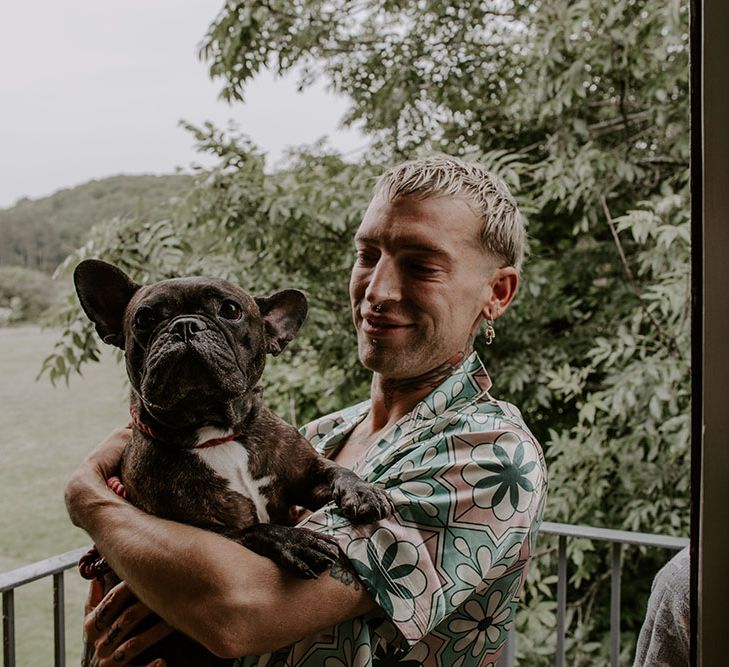 Groom carries his dog on the morning of his wedding day 