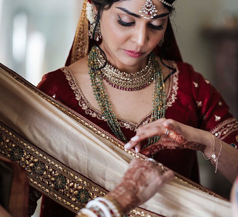 Bride in traditional Indian wedding attire with a sparkly headdress 