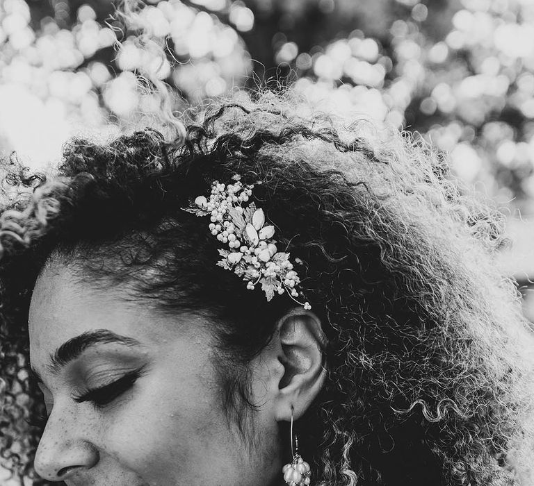 Bride with a gold autumnal leaf hair clip with pearls and pearl earrings 