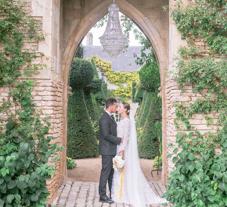 Euridge Manor wedding venue with chandelier with the bride and groom embracing 