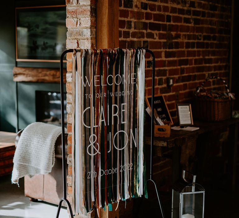 Deep toned colourful ribbons wedding welcome sign for the boho wedding at Silchester Farm 