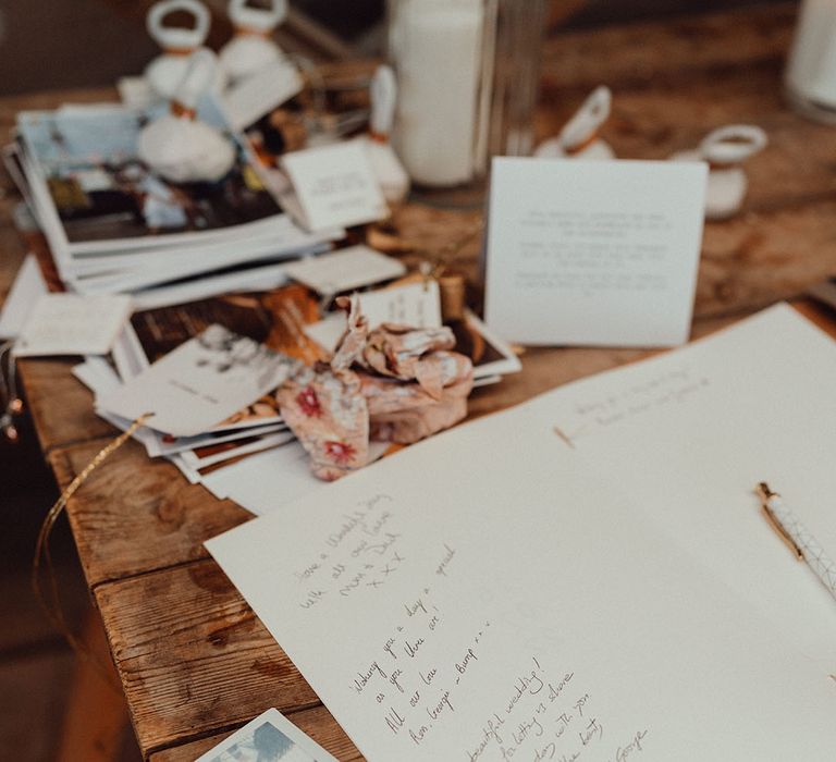 Hand bound wedding guest book with personal handwritten messages for the wedding guests with polaroid pictures 