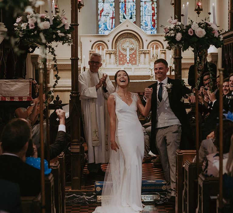 Bride & groom celebrate during church wedding ceremony 