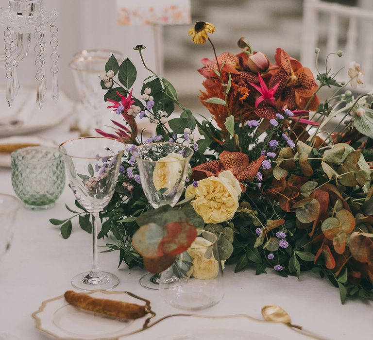 elegant wedding place setting with colourful flower centrepiece 