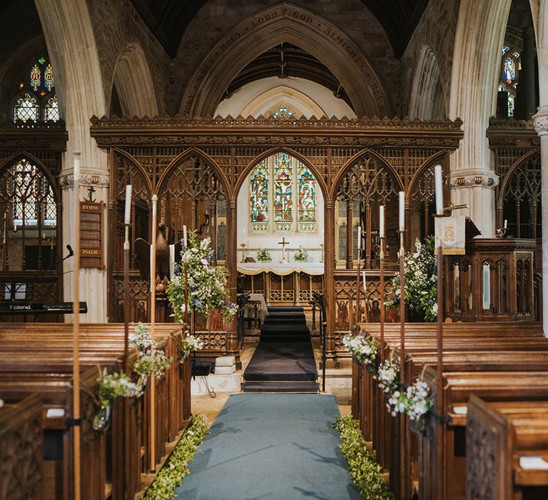 Church wedding ceremony with candles and daisy flower decor for a traditional Christian wedding 