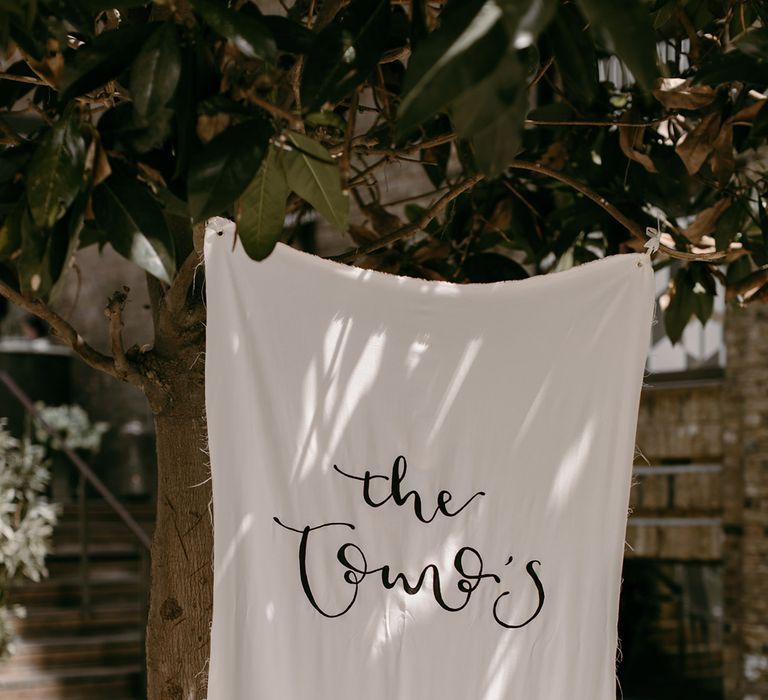 The bride made the black and white fabric wedding sign for the modern city wedding 