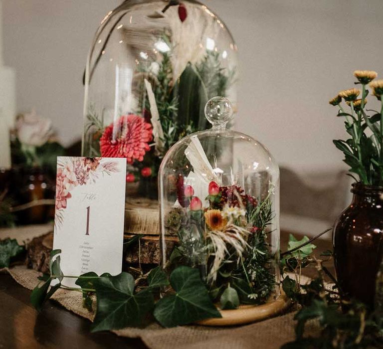 Glass dome wedding decorations with botanical luxe wedding table number on burlap wedding table runner at The Barn at Avington 