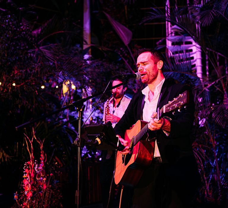 A live wedding band playing at the luxury glasshouse wedding venue 