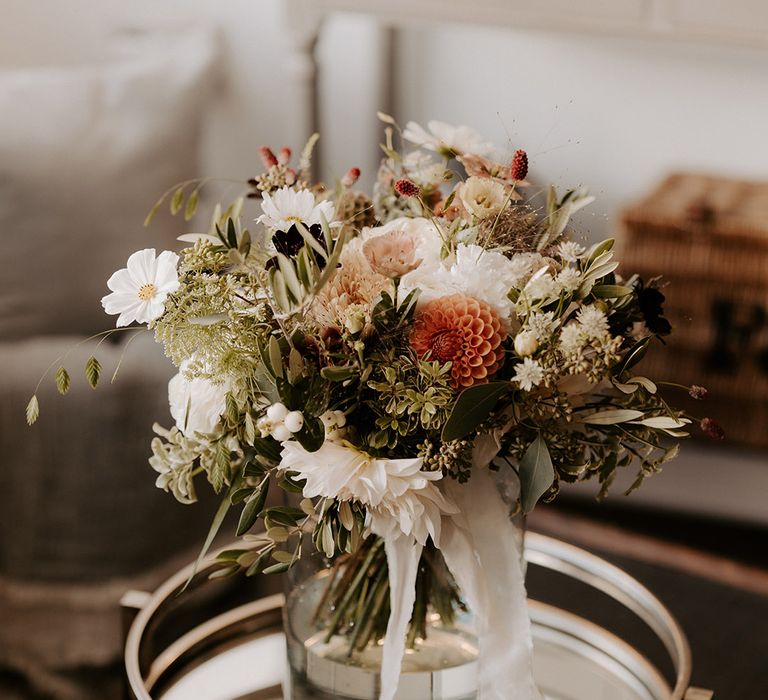 The bride's neutral wedding bouquet with dahlias, cosmos, and roses 