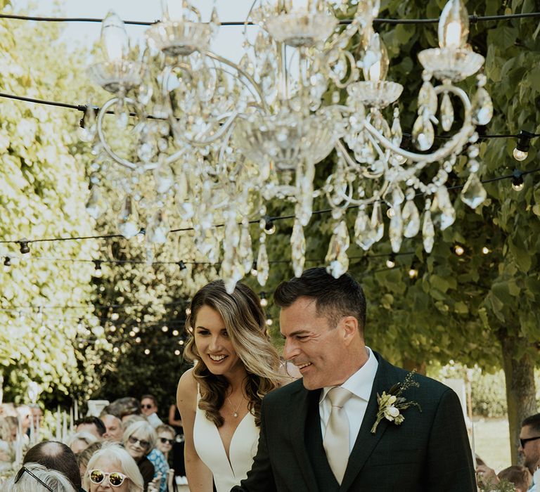 Al fresco outdoor wedding breakfast at Kelmarsh Hall and Gardens with crystal chandelier decorations