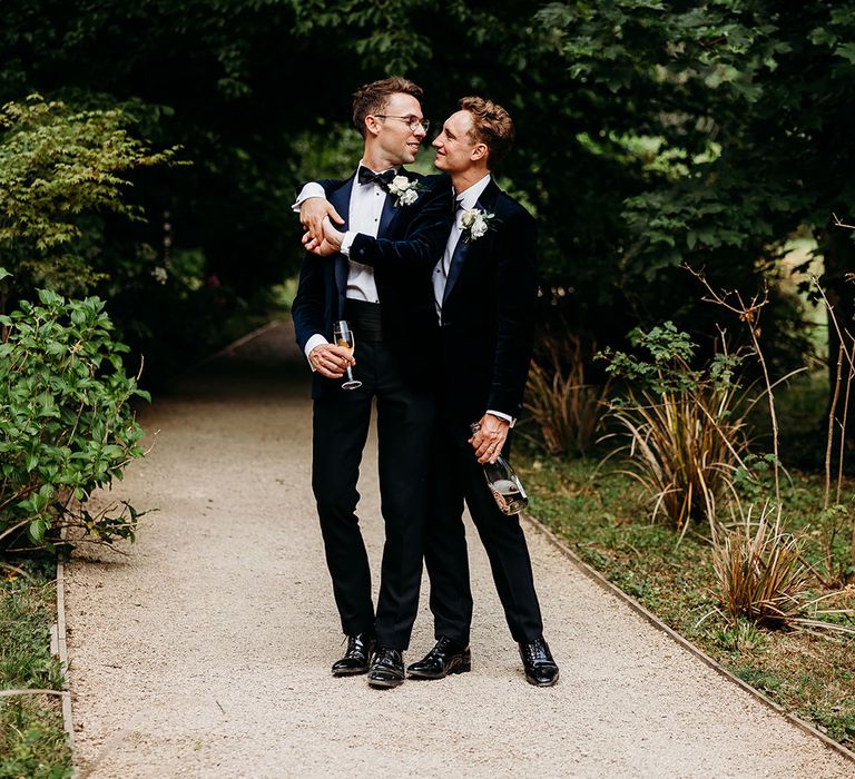 LGBTQI+ wedding with two groom in black tie for the traditional dress code