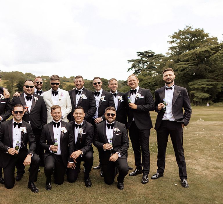 Groomsmen wearing black tuxedos 