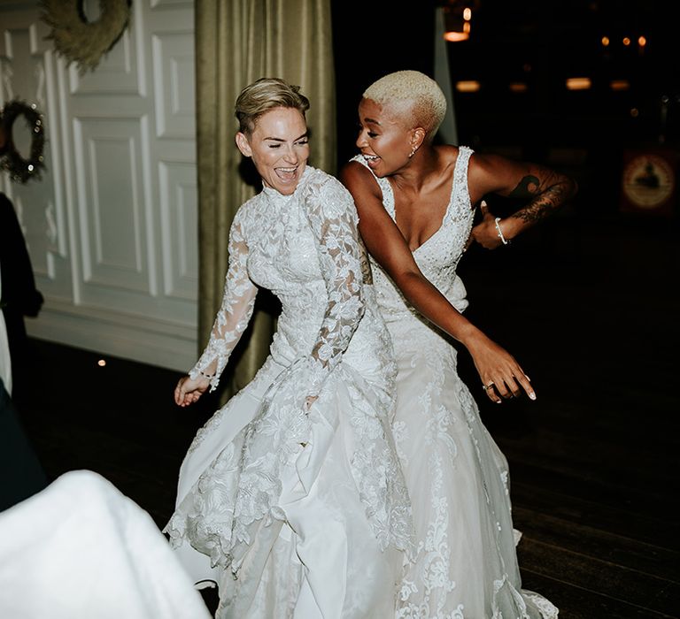 Lesbian wedding with two brides dancing at their wedding reception at Sant Ffraed House