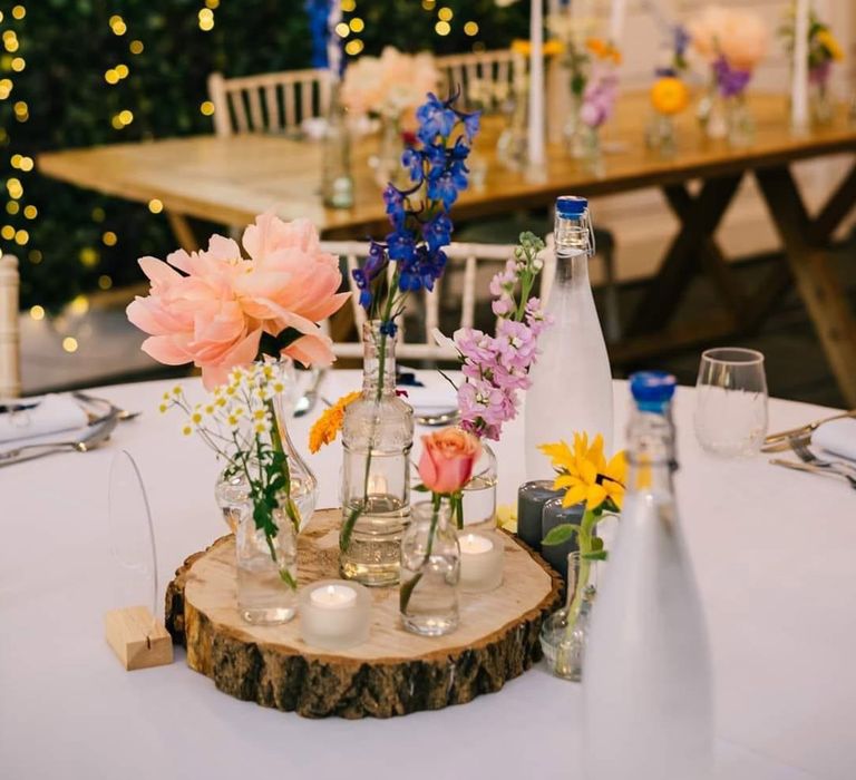 Delicate buds vases filled with summer wildflowers for summer wedding table centrepiece ideas 