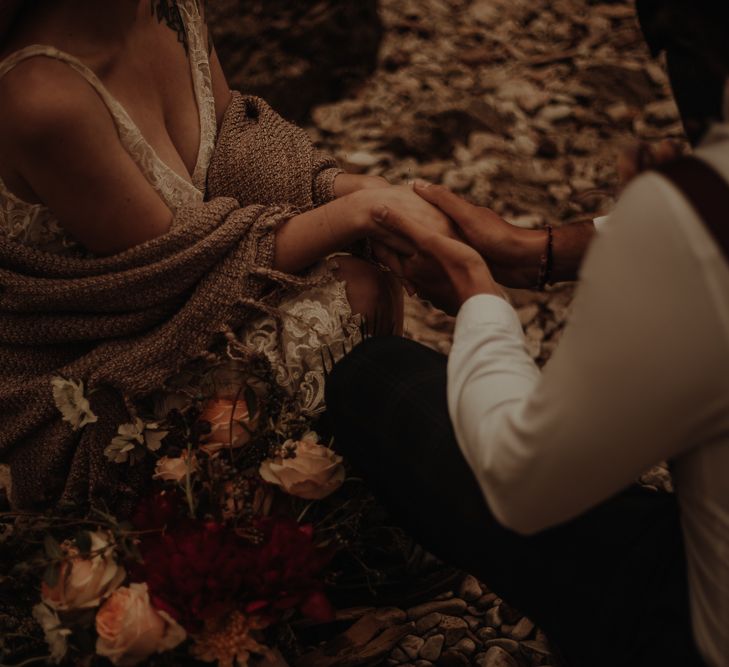 Bride and groom holding hands at intimate beach elopement