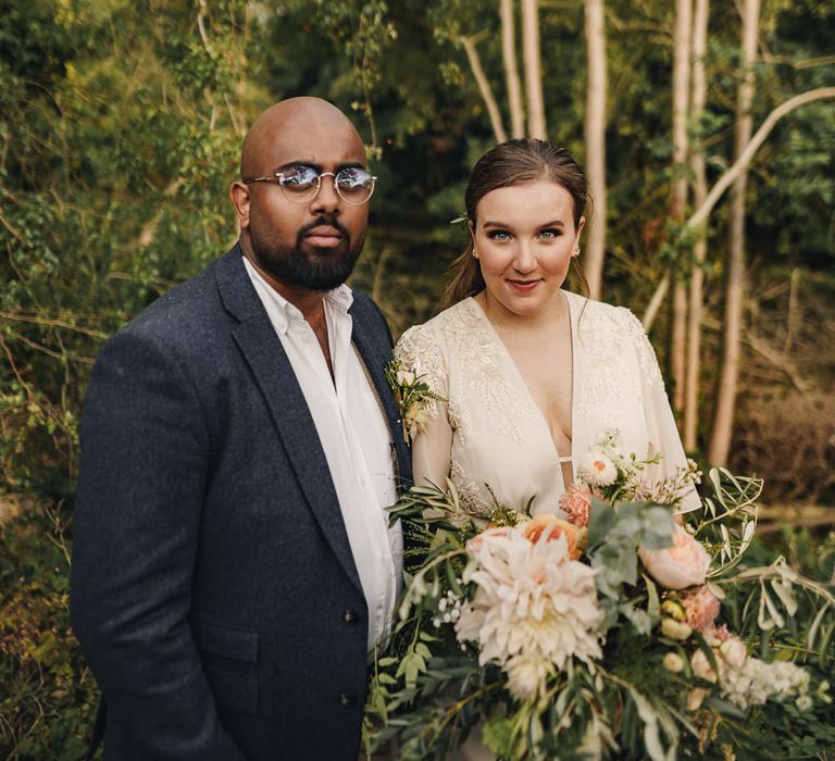 Bride in Hope & Ivy dress and groom in Moss Bros. suit at micro wedding 