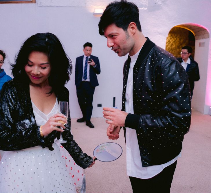 Stylish bride and groom in polka dot jacket and skirt 