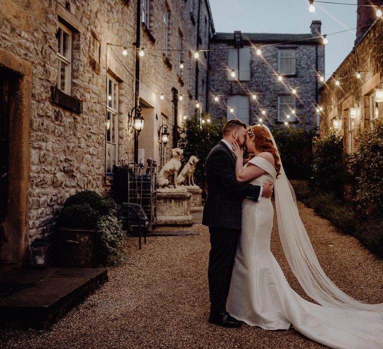 Bride and groom portrait in the courtyard at Holmes Mill by Louise Griffin Photography