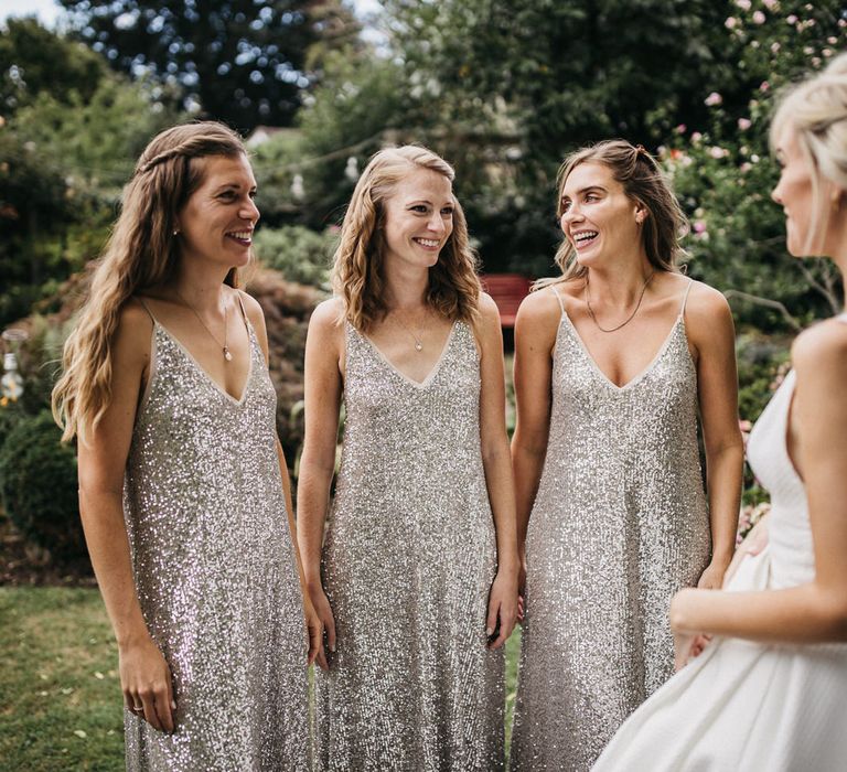 First look with the bridesmaids in silver sequin midi dresses 